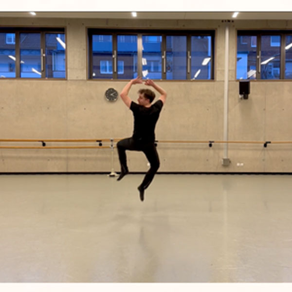 Video still of a choreographer/danger mid spin in the air