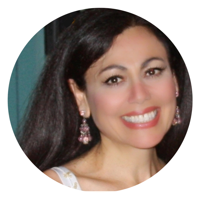 Woman with long dark hair, wearing earrings smiling