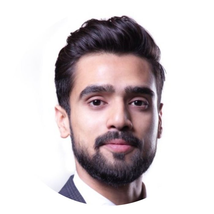 Man with dark hair styled into pompadour with trimmed beard smiling